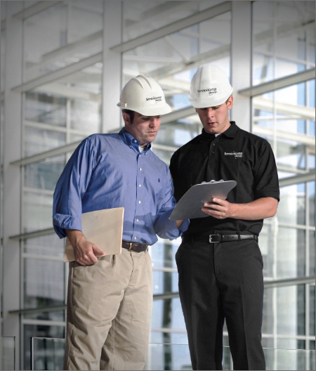 Service Master Employees looking at a clipboard