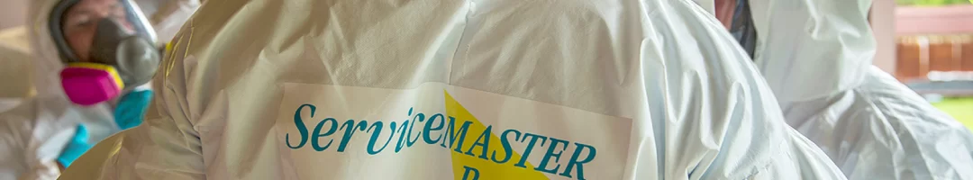 servicemaster team in biohazard suits